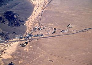 Aerial view of Baker looking north: I-15 jogs south around the town, leaving Baker Boulevard, the main street, to show where the pre-interstate highway (US 91 and US 466) went. Baker Airport sits just north of the city alongside northbound CA 127, the "Death Valley Road".   View of Baker from the east on I-15