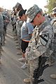 US Army 51759 Soldiers bow their heads during a moment of silence before going on a commemorative march on Forward Operating Base Warrior, Kirkuk, Iraq, Sept. 11. The march gave Soldiers the opportunity to reflect