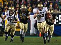 US Navy 051203-N-2383B-223 U.S. Naval Academy Midshipman fullback Adam Ballard (22) rushes for one of two touchdowns while being persued by Army defenders Cason Shrode (54) and Taylor Justice (42)