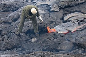 Sampling lava with hammer and bucket