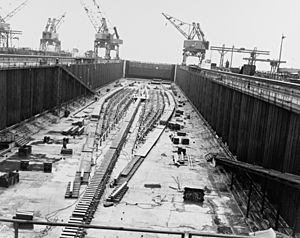 The keel plate of USS United States (CVA-58) being laid in a construction dry dock on 18 April 1948