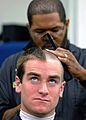 US Navy 090701-N-8395K-001 A plebe receives his first Navy haircut during Induction Day at the U.S. Naval Academy