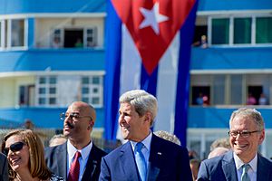 Secretary Kerry Laughs as the Crowd Across the Street Yells "Viva Cuba" at End of Playing of Cuban National Anthem (20564842702)