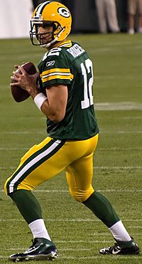 Aaron Rodgers drops back (cropped)