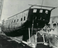 Photograph of a ship out of the water and partially disassembled