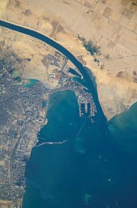 Satellite view of the port and city that are the southern terminus of the Suez Canal that transits through Egypt and debouches into the Mediterranean Sea near Port Said