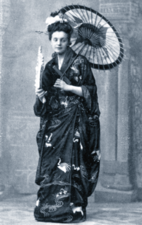 Young European woman wearing traditional Japanese costume, carrying a parasol