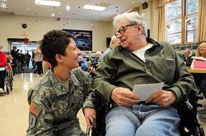 Defense.gov News Photo 101215-F-0681L-2552 - U.S. Army Staff Sgt. Amy Wieser Willson left with the 231st Brigade Support Battalion North Dakota National Guard visits with a resident of the