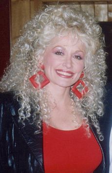 Dolly Parton with square red earrings