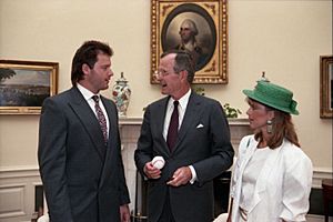 President George H. W. Bush meets with Roger Clemens and his wife in the Oval Office, and they exchange signed baseballs