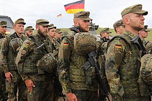 German army soldiers stand at attention for the Georgian natinal anthem during Noble Partner 18 at Vaziani Training Area, Georgia.jpg