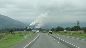 Approaching Tully from the south on the Bruce Highway, the steam rising is from the Tully Sugar Mill, 2016