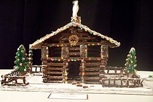 Log gingerbread house with trees