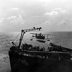 SOC scoutplane is hoisted on board, during recovery by USS Philadelphia (CL-41)