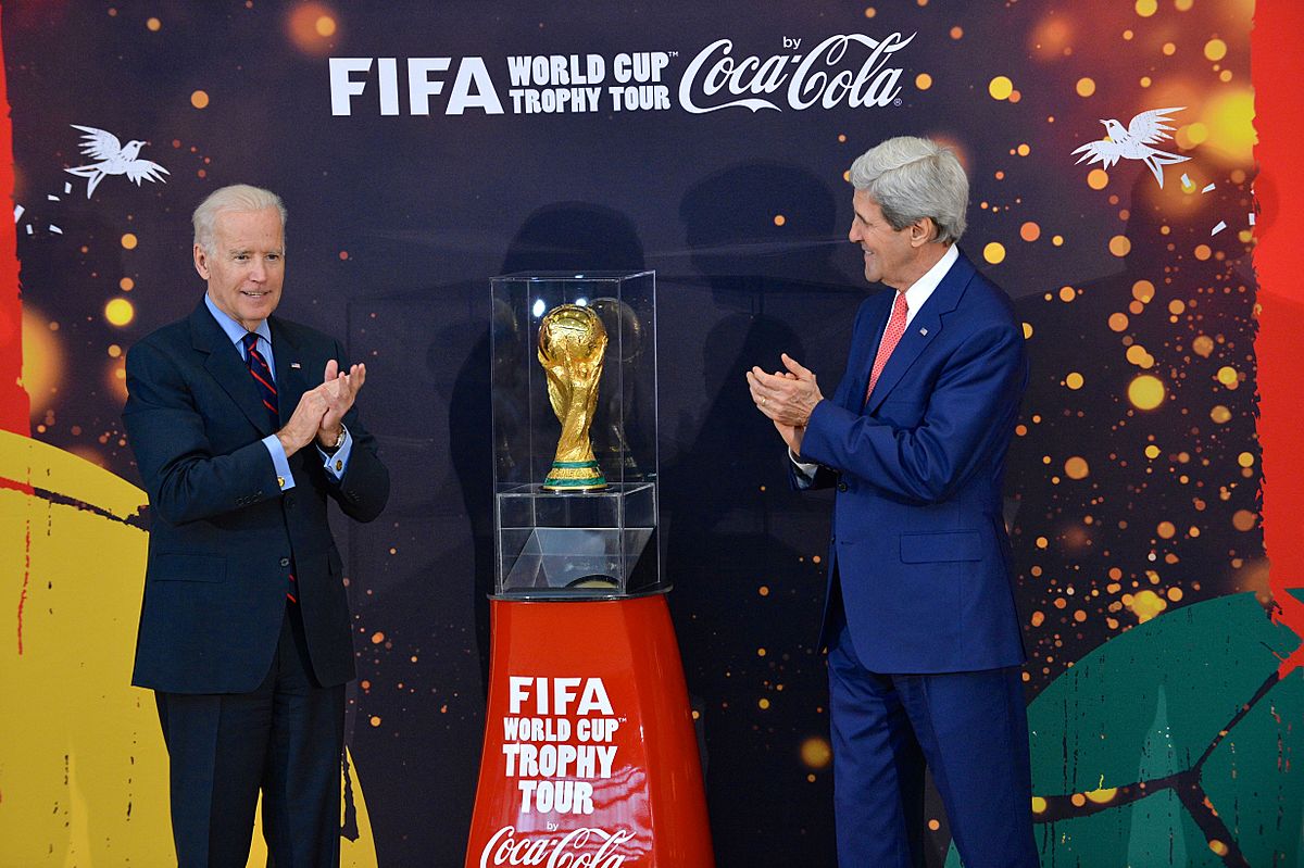 Vice President Joe Biden and Secretary of State John Kerry applaud the FIFA World Cup trophy at the U.S. Department of State.jpg