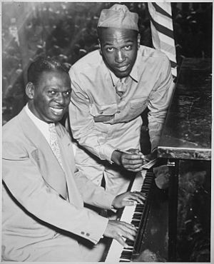 "Earl `Father' (Fatha) Hines, a great swing musician, is shown with Pvt. Charles Carpenter, former manager of the Hines - NARA - 535834