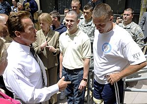 US Navy 100729-N-0208R-156 California Gov. Arnold Schwarzenegger speaks with Hospital Corpsman 3rd Class Anthony Ameen, center, and Marine Sgt. Maj. Patrick A. Wilkinson