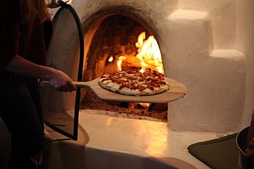 Pizza baking in Wood-fired oven