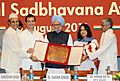 Manmohan Singh presenting the “Rajiv Gandhi National Sadbhavana Award” to Dr. Kiran Seth of SPIC MACAY, at a function, in New Delhi. The President of ICCR, Dr. Karan Singh and the Member of Parliament