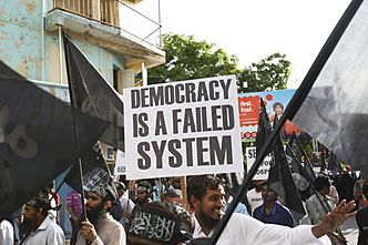 Street protest calling for Sharia in Maldives, Democracy failed system poster