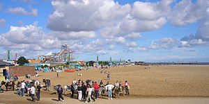 Panoramic image of the beach crowded with people.