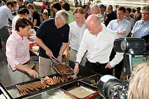 Foreign Secretary helping at the barbecue (5369151185)