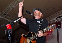 Playing to the base, Toby Keith sings at Camp Buehring during his 'Live In Overdrive' USO tour 120426-A-OQ455-001