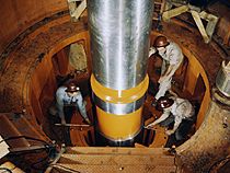 Checking the alignment of a turbine shaft at the top of the guide bearing in TVA's hydroelectric plant, Watts Bar Dam, Tenn