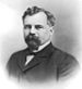 Upper-body portrait of a late-nineteenth-century man in a suit.