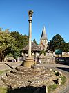 Shere war memorial with St James in the background.jpg