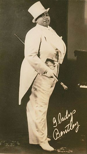 A black-and-white photo of Bentley in a white tail coat, holding a cane and wearing a top hat