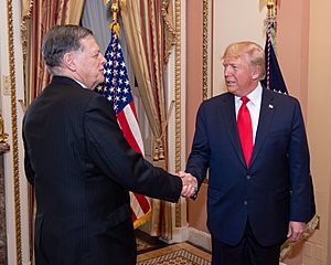 President Donald Trump shaking hands with Congressman Tom Cole