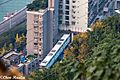 A train of Chongqing Rail Transit Line 2 coming through a residential building at Liziba