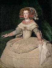 A girl stands against a dark background, wearing an extravagant, wide, white Baroque dress. Her brown hair is equally lavishly adorned.