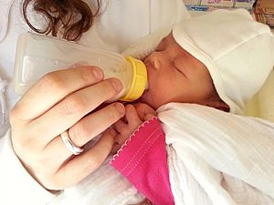 Infant drinks milk from bottle