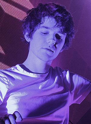 Madeon bathed in a violet light.