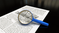 Magnifying glass with focus on paper