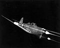 Bell P-39 Airacobra in flight firing all weapons at night