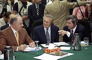 Ahmed Chalabi in discussion with Paul Bremer and Donald Rumsfeld