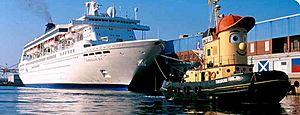 Tour boat Theodore Too escorts cruise ship Norwegian Sea docking at Halifax Harbour in 2003