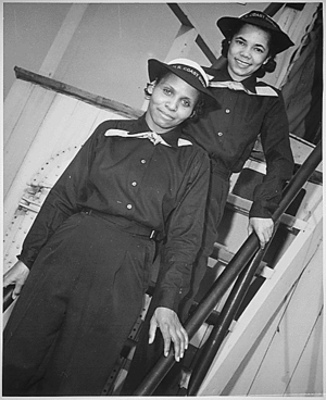 Two Negro SPARS pause on the ladder of the dry-land ship `U.S.S. Neversail' during their `boot' training at the U.S. Coast Guard Training Station, Manhattan Beach, Brooklyn, NY