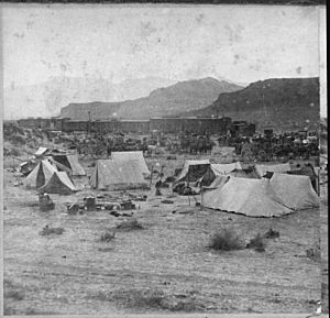 "End of the Track. Near Humboldt River Canyon, Nevada." Campsite and train of the Central Pacific Railroad at foot of mo - NARA - 533792