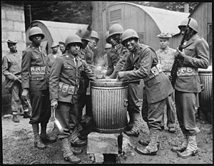 "Negro soldiers draw rations at the camp cook house at their station in Northern Ireland. Detachments of Negro troops we - NARA - 535544