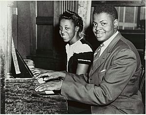 Oscar Peterson with his sister, Daisy, at the piano - 1944.jpg