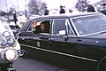 Richard Nixon waves in presidential limousine