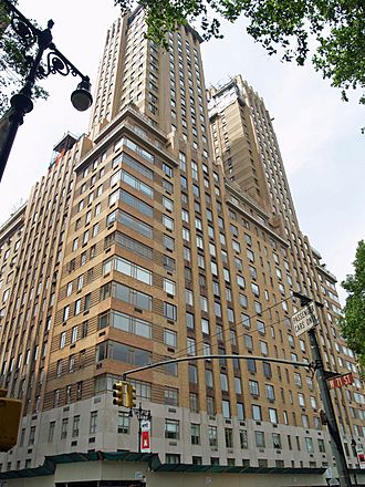 The Majestic apartment building as seen at ground level from 71st Street and Central Park West. The first three stories are clad with stone, while the rest of the facade is made of brick. Above the 19th story are two towers clad with brick.