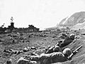 Marines burrow in the volcanic sand on the beach of Iwo Jima