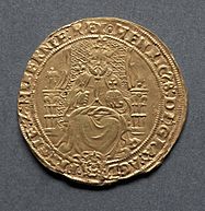 Gold coin showing a man seated on a chair