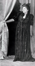 White woman in full-length, loose fitting black frock