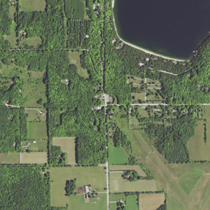 Main Road (center) runs north–south and forms a T intersection with Jackson Harbor Road running east. County Trunk Highway W coincides with Little Lake Road (top left), which runs east–west. Little Lake Road turns south and ends with a junction at Main Road. At the southeast terminus of Little Lake Road, CTH W continues, following south along Main Road. Washington Harbor is at the top right.